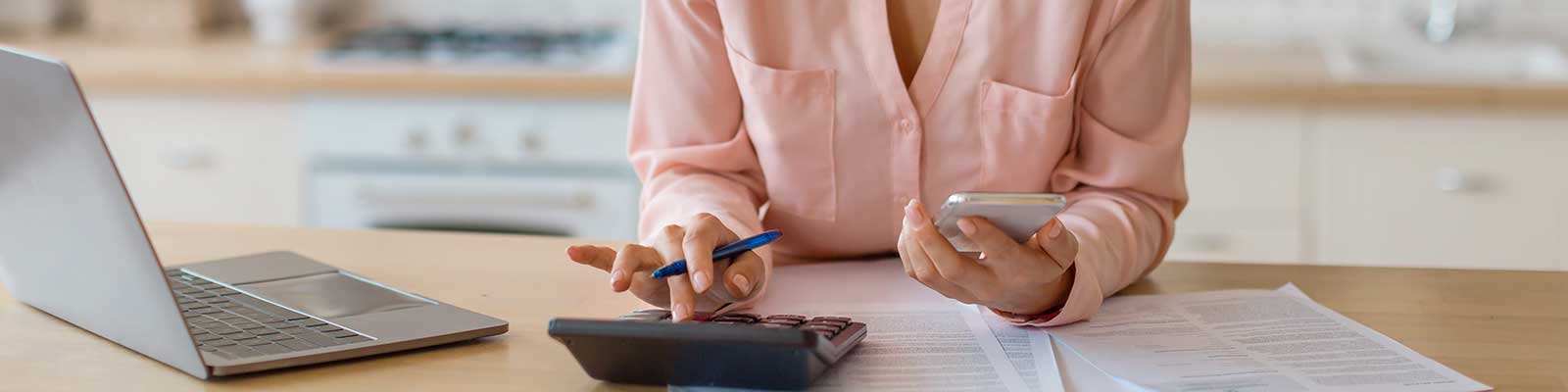 woman with calculator and laptop