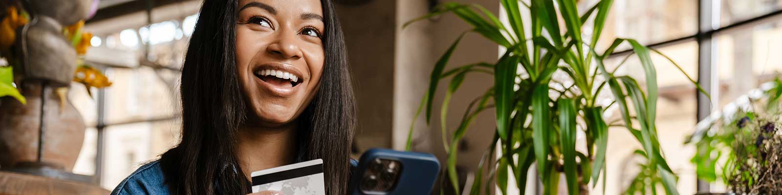 Young woman with a phone and debit card